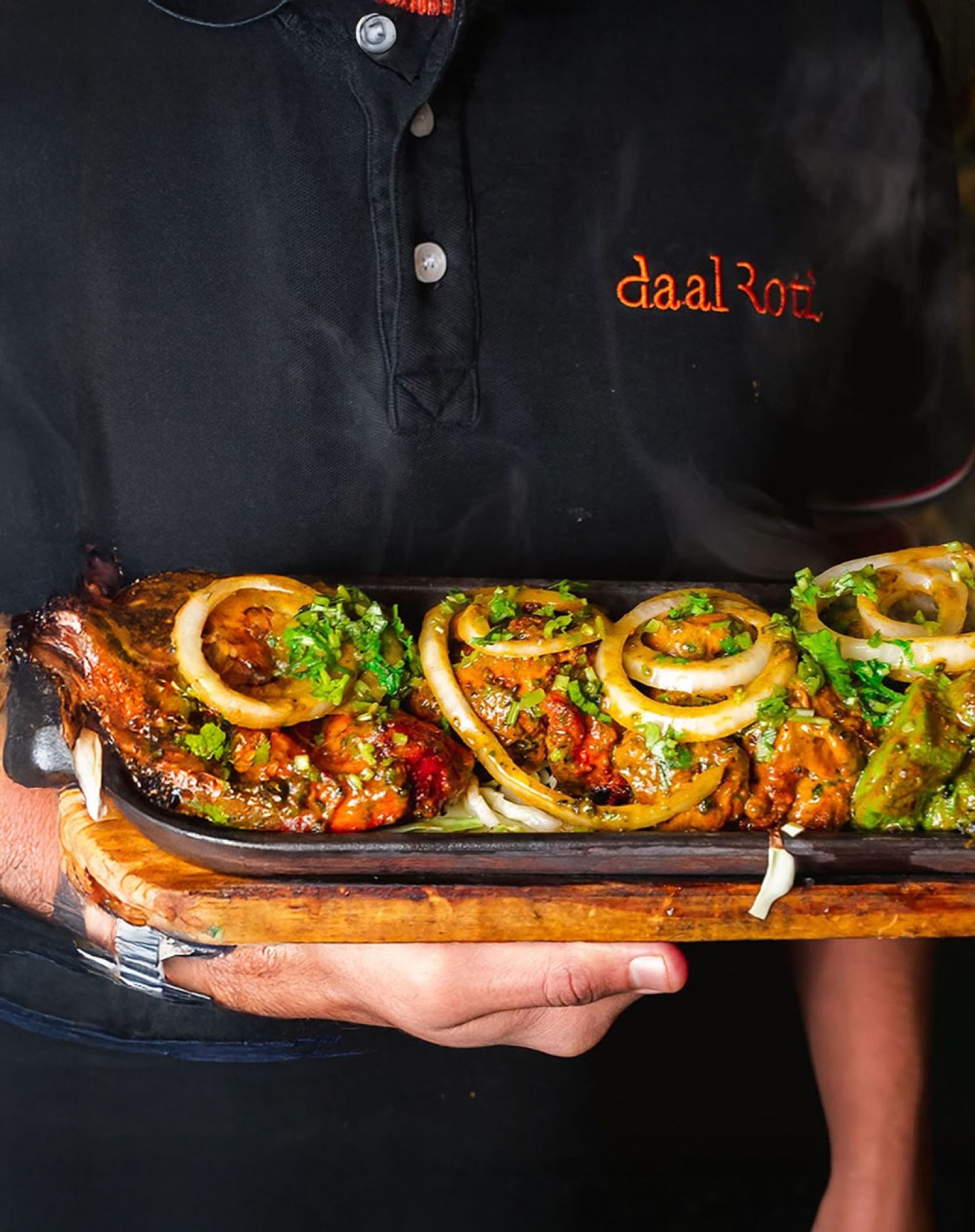 Daal Roti chef with sizzler platters